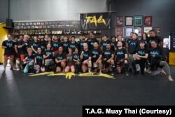 Thai female fighter Stamp Fairtex (middle, front row) takes a group photo with participants of her Muay Thai seminar at T.A.G. Muay Thai in Sterling, VA, in October 2022.