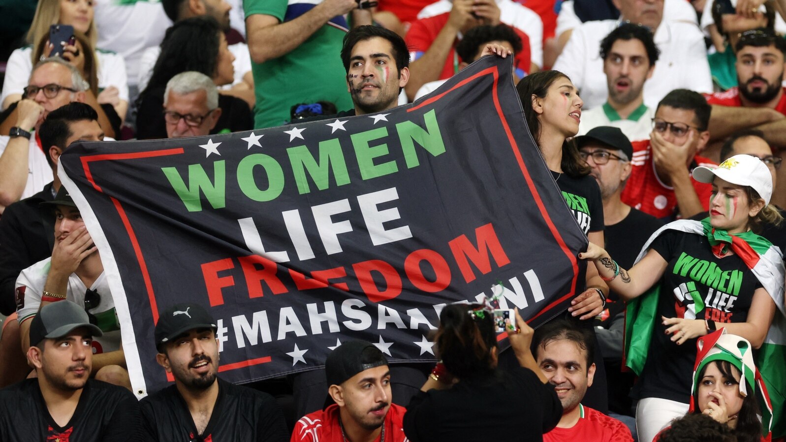 Iran fans hold a banner reading 'Woman life freedom' inside the stadium during the Group B match between England and Iran at Khalifa International Stadium, Doha, Qatar, on Nov. 21, 2022.
