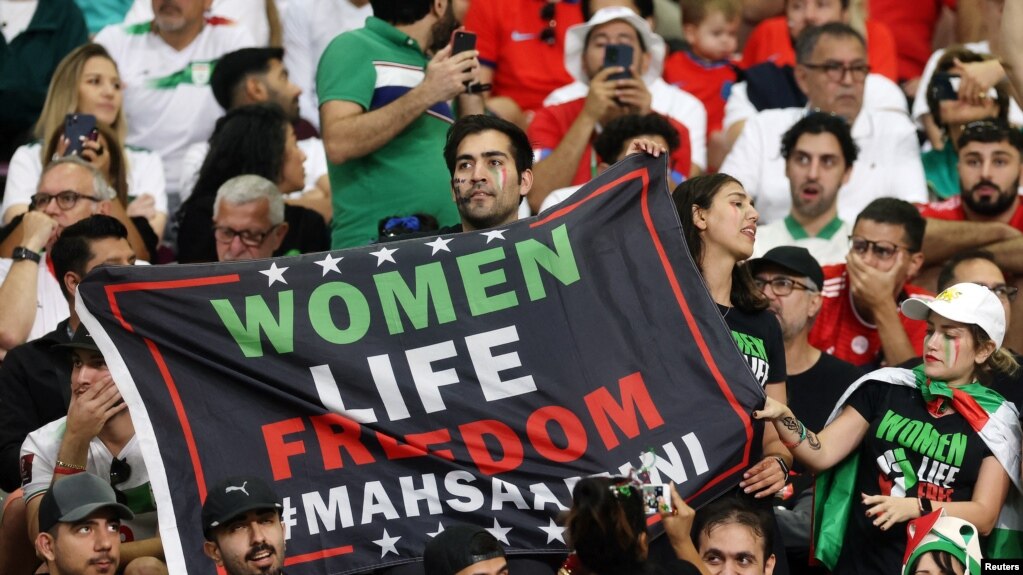 Iran fans hold a banner reading 'Woman life freedom' inside the stadium during the Group B match between England and Iran at Khalifa International Stadium, Doha, Qatar, on Nov. 21, 2022.