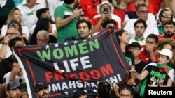 Iran fans hold a banner reading 'Woman life freedom' inside the stadium during the Group B match between England and Iran at Khalifa International Stadium, Doha, Qatar, on Nov. 21, 2022.