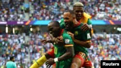 Cameroon's Vincent Aboubakar and Eric Maxim Choupo-Moting celebrate a goal against Serbia at the 2022 FIFA World Cup, November 28, 2022