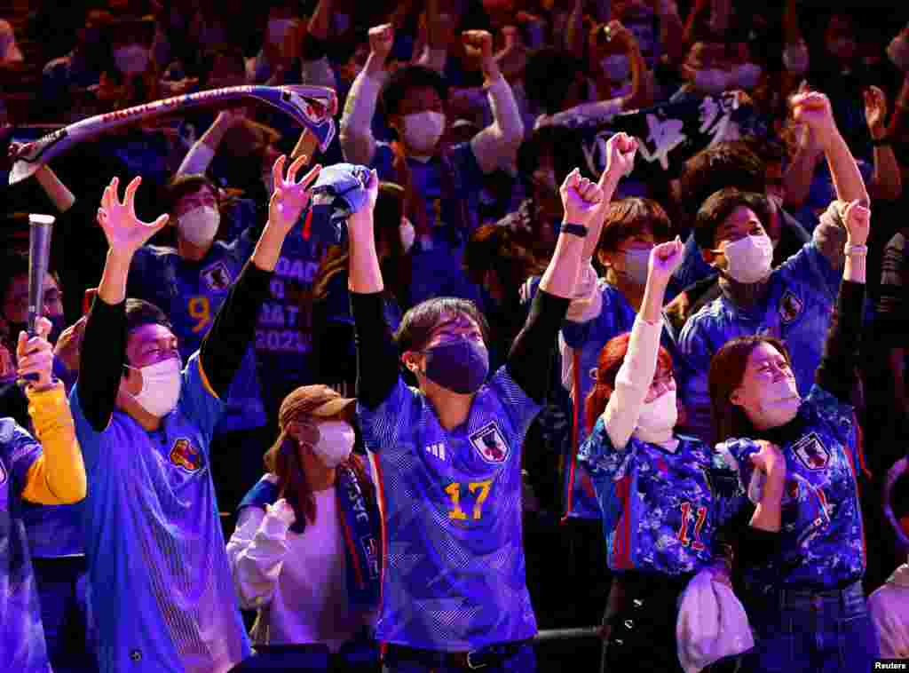 Japanese soccer fans react after Japan won a FIFA World Cup Qatar 2022 match with Germany, at a public viewing event in Tokyo, Japan.