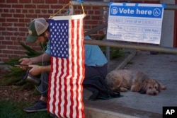 FILE -- A sign outside of a Los Angeles, California, polling station provides voting information in Chinese, Hindi, Japanese, Cambodian/Khmer, Korean, Spanish, Tagalog, Thai, and Vietnamese. (AP Photo/Damian Dovarganes)