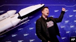 FILE - SpaceX owner and Tesla CEO Elon Musk arrives on the red carpet for the Axel Springer media award, in Berlin, Dec. 1, 2020. 