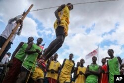 A Maasai man competes in the high-jump competition at the Maasai Olympics in Kimana Sanctuary, southern Kenya Saturday, Dec. 10, 2022. (AP Photo/Brian Inganga)