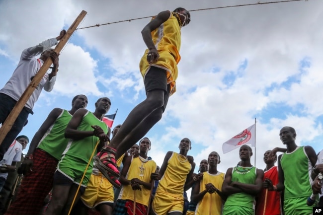 A Maasai man competes in the high-jump competition at the Maasai Olympics in Kimana Sanctuary, southern Kenya Saturday, Dec. 10, 2022. (AP Photo/Brian Inganga)