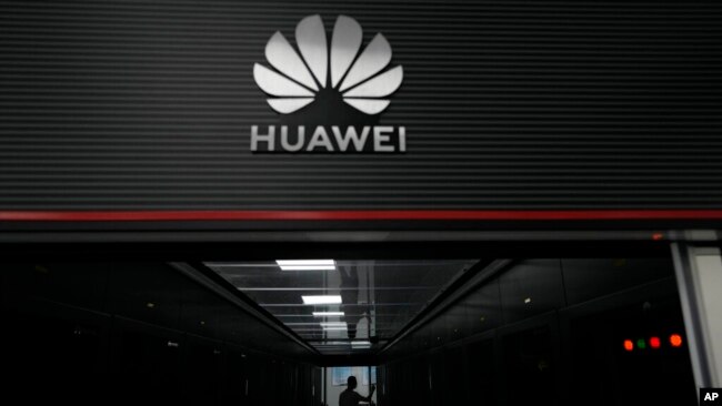 FILE - A technician stands at the entrance to a Huawei 5G data server center in Guangzhou, in southern China's Guangdong province on Sept. 26, 2021.