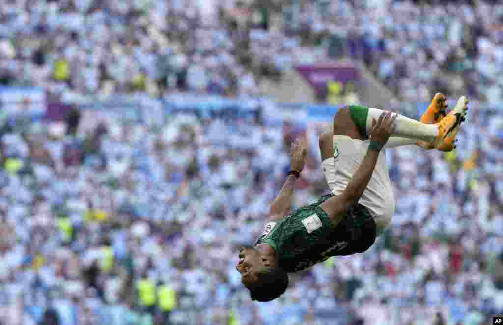 Saudi Arabia&#39;s Salem Al-Dawsari celebrates after scoring his side&#39;s second goal during the World Cup group C soccer match between Argentina and Saudi Arabia at the Lusail Stadium in Lusail, Qatar.