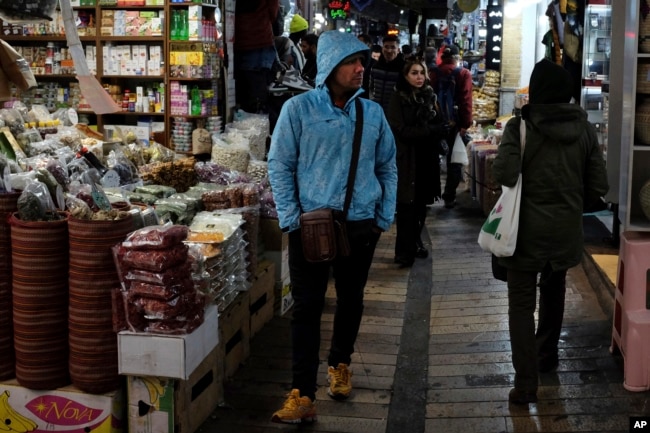 People conduct their business at Tajrish bazaar in northern Tehran, Iran, Monday, Dec. 5, 2022. (AP Photo/Vahid Salemi)