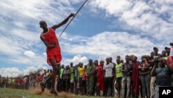 A Maasai man throws a javelin as he competes in the Maasai Olympics in Kimana Sanctuary, southern Kenya Saturday, Dec. 10, 2022. (AP Photo/Brian Inganga)