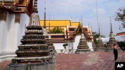 FILE - A tourist visits Wat Pho temple in Bangkok, Thailand, Feb. 23, 2022. Thailand’s economy, heavily dependent upon tourism, is forecast to grow 3.6% in 2023, the World Bank reported.