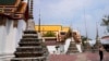 FILE - A tourist visits Wat Pho temple in Bangkok, Thailand, Feb. 23, 2022. 