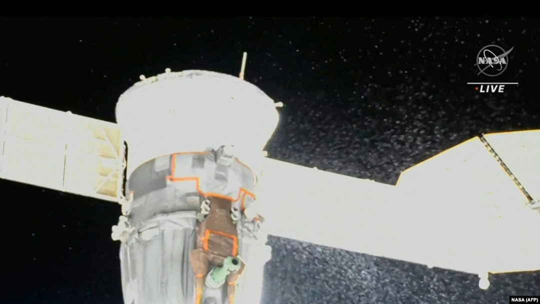 Video grab from a NASA feed obtained Dec. 15, 2022, shows liquid spraying from the aft end of the Soyuz MS-22 spacecraft, NASA said on Dec. 15, 2022. (AFP PHOTO/NASA)