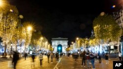 Spectators gather to attend the Champs Elysee Avenue illumination ceremony for the Christmas season, in Paris, Nov. 20, 2022.