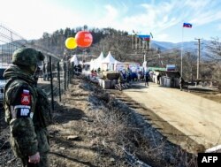 FILE - A Russian peacekeeper guards the Lachin corridor, the Armenian-populated breakaway Nagorno-Karabakh region's only land link with Armenia, Dec. 27, 2022.