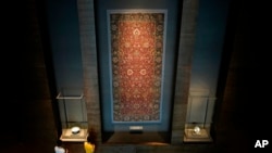 Visitors view an Iranian carpet at the Museum of Islamic Art in Doha, Qatar, Nov. 22, 2022. 