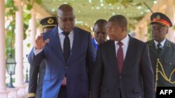 FILE - President of Democratic Republic of the Congo Felix Tshisekedi (L) gestures as he walks with President of Angola Joao Lourenco during his first visit in Luanda, Angola, Feb. 5, 2019.