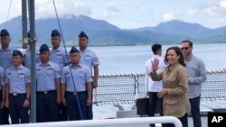 In this photo provided by the Philippine Coast Guard, U.S. Vice President Kamala Harris waves on board the Philippine Coast Guard BRP Teresa Magbanua (MRRV-9701) during her visit to Puerto Princesa, Palawan province, western Philippines, Nov. 22, 2022. 