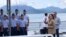 In this photo provided by the Philippine Coast Guard, U.S. Vice President Kamala Harris waves on board the Philippine Coast Guard BRP Teresa Magbanua (MRRV-9701) during her visit to Puerto Princesa, Palawan province, western Philippines, Nov. 22, 2022. 
