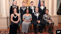 2022 Kennedy Center Honorees, front row from left, Amy Grant, Gladys Knight, George Clooney, Tania Leon, join, back row from left, Adam Clayton, Larry Mullen Jr., The Edge, and Bono for a group photo following the Kennedy Center Honors gala dinner, Dec. 3, 2022, in Washington.