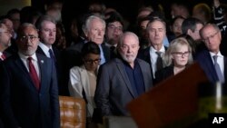 Brazil's President Luiz Inacio Lula da Silva, center, president of the Supreme Court Rosa Weber, center right, are accompanied by governors and ministers for an inspection visit and support for the Supreme Court headquarters on Jan. 9, 2023.