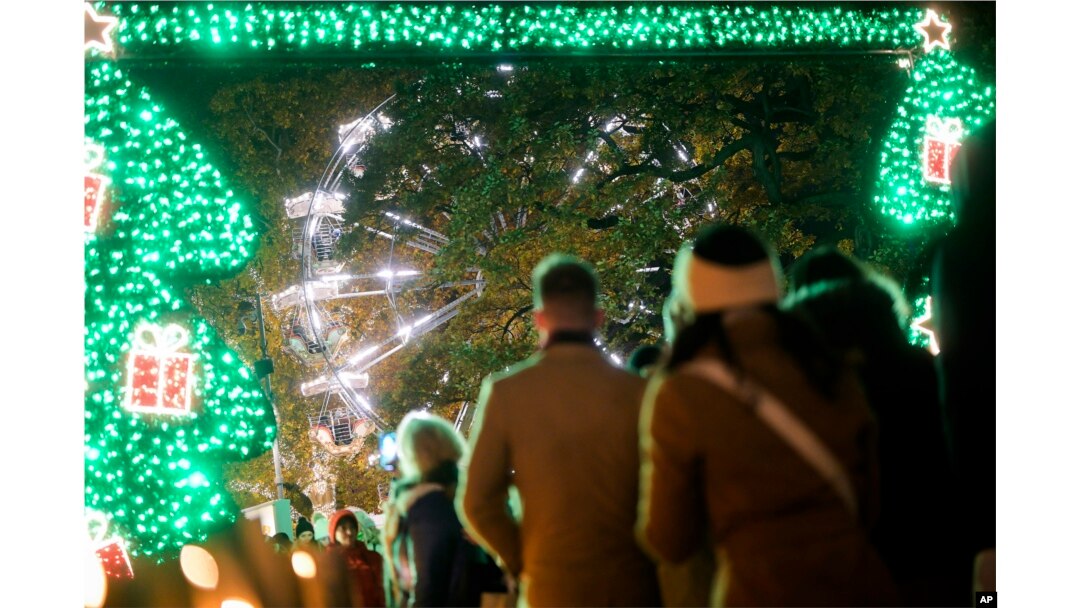 Para pengunjung berjalan di Wiener Chritkindlmarkt, salah satu pasar Natal paling populer di Wina, Austria, Sabtu, 19 November 2022. (AP/Michael Gruber)