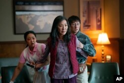 This image released by A24 Films shows, from left, Stephanie Hsu, Michelle Yeoh and Ke Huy Quan in a scene from, "Everything Everywhere All At Once."