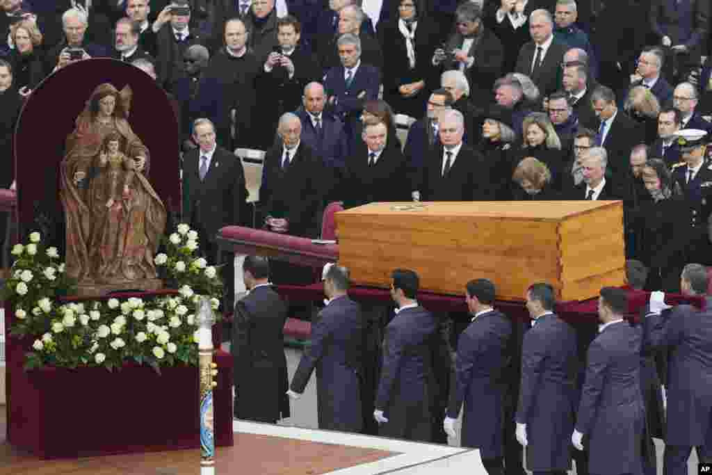 The coffin of late Pope Emeritus Benedict XVI is carried after a funeral mass in St. Peter's Square at the Vatican, Jan. 5, 2023. 