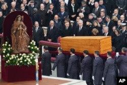 The coffin of late Pope Emeritus Benedict XVI is carried after a funeral mass in St. Peter's Square at the Vatican, Jan. 5, 2023.