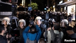 FILE - Riot police officers block the way as journalists try to report on a protest, in Istanbul, Turkey, Oct. 26, 2022.
