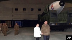 This photo provided on Nov. 19, 2022, by the North Korean government shows North Korean leader Kim Jong Un and his daughter inspecting a missile at Pyongyang International Airport in Pyongyang, North Korea, Nov. 18, 2022.