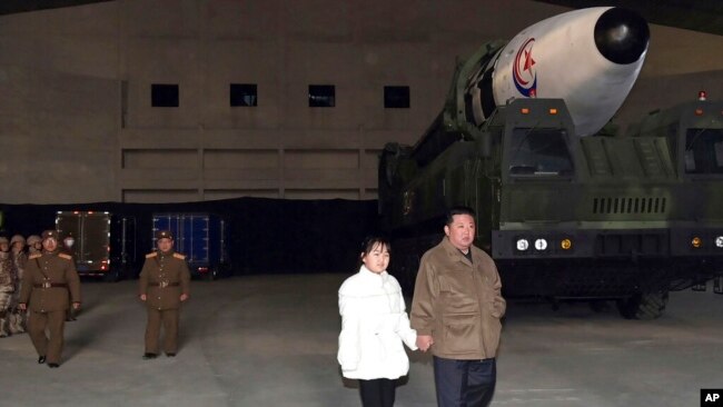 This photo provided on Nov. 19, 2022, by the North Korean government shows North Korean leader Kim Jong Un and his daughter inspecting a missile at Pyongyang International Airport in Pyongyang, North Korea, Nov. 18, 2022.