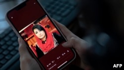 A photo of former Afghan lawmaker Mursal Nabizada who was shot dead by gunmen last night at her house in Kabul is seen on a mobile phone in Kabul, Afghanistan, Jan. 15, 2023.