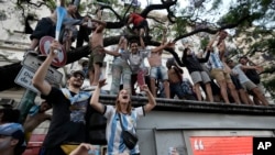 Argentina soccer fans celebrate their team's victory over Croatia after watching the team's World Cup semifinal match in Qatar on TV, in downtown Buenos Aires, Argentina, Dec. 13, 2022. 