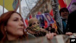 Activists march in Paris, Jan. 7, 2023, to show anger over the unresolved killing of three Kurdish women activists in 2013 and grief over three people killed outside a Kurdish cultural center in Paris two weeks ago in what prosecutors called a racist attack.