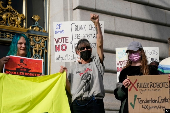 Denise Dorey, middle, reacts to speakers while taking part in a demonstration about the use of robots by the San Francisco Police Department outside of City Hall in San Francisco, Monday, Dec. 5, 2022. (AP Photo/Jeff Chiu, File)