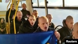 Ukrainian troops sing their national anthem after being released in a prisoner swap with Russia, at an unidentified location in Ukraine, in this screengrab taken from a handout video released Jan. 8, 2023. (Andriy Yermak via Telegram/Handout via Reuters)