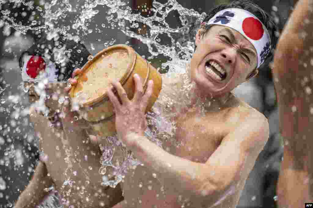 Shinto believers take a bath in cold water to purify their souls and bodies during a New Year ritual at Kanda Myojin Shrine in Tokyo, Japan, Jan. 14, 2023.