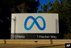 FILE - Meta's logo can be seen on a sign at the company's headquarters in Menlo Park, California, on Nov. 9, 2022.