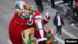 Santa Claus waves to the crowd during the 96th Macy's Thanksgiving Day Parade in New York, Nov. 24, 2022.