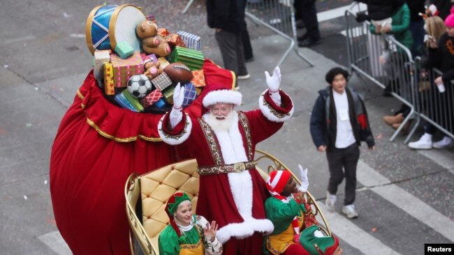 Santa Claus waves to the crowd during the 96th Macy's Thanksgiving Day Parade in New York, Nov. 24, 2022.