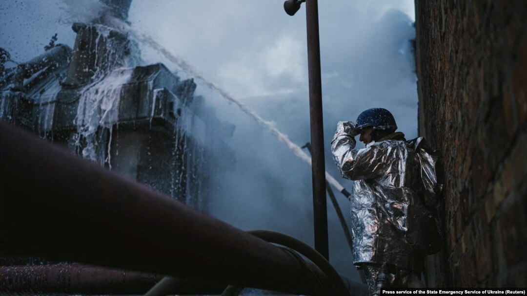 A firefighter extinguishes a fire at a critical power infrastructure, which was hit during Russia's drones attacks in Kyiv, Ukraine, Dec. 19, 2022.