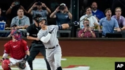 FILE - New York Yankees' Aaron Judge follows through on a solo home run, his 62nd of the season on Oct. 4, 2022. (AP Photo/Tony Gutierrez)