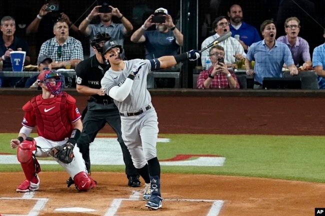 FILE - New York Yankees' Aaron Judge follows through on a solo home run, his 62nd of the season on Oct. 4, 2022. With the homer, Judge set the AL record for home runs in a season, passing Roger Maris. (AP Photo/Tony Gutierrez)