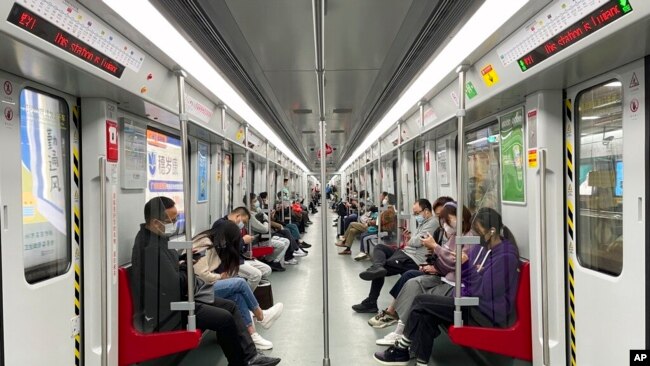 Residents ride public transport in the district of Haizhu as pandemic restrictions are eased in southern China's Guangzhou province, Dec. 1, 2022.