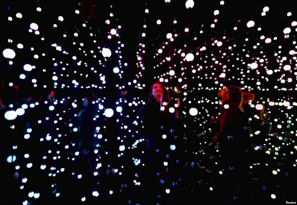 People visit the exhibition Incanto di Luci (Enchantment of Lights) along an illuminated trail set up at the Botanical Garden in Rome, Italy, Dec. 7, 2022. 
