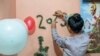 A Christian girl named Nijjar, 15, decorates her family home on Coptic Christmas Eve in Cairo, Egypt. (Hamada Elrasam/VOA)