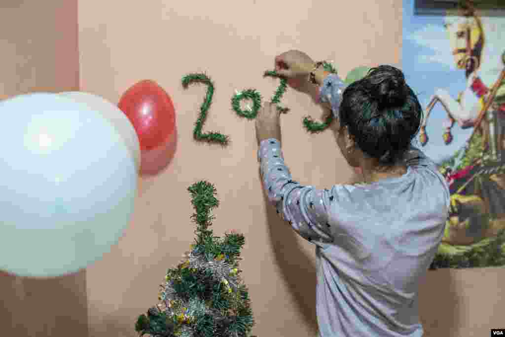 A Christian girl named Nijjar, 15, decorates her family home on Coptic Christmas Eve in Cairo, Egypt. (Hamada Elrasam/VOA)
