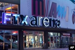 Signage for the FTX Arena, where the Miami Heat basketball team plays, is illuminated on Saturday, Nov. 12, 2022, in Miami. (AP Photo/Marta Lavandier, File)