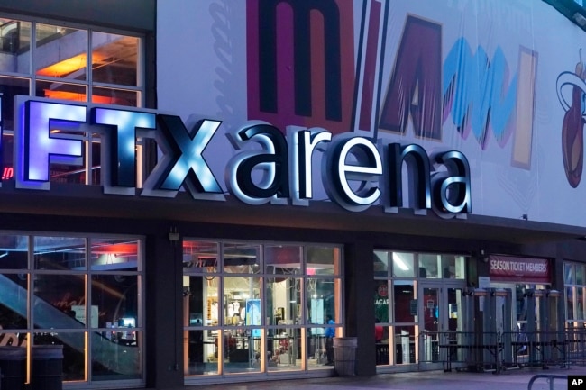 Signage for the FTX Arena, where the Miami Heat basketball team plays, is illuminated on Saturday, Nov. 12, 2022, in Miami. (AP Photo/Marta Lavandier, File)